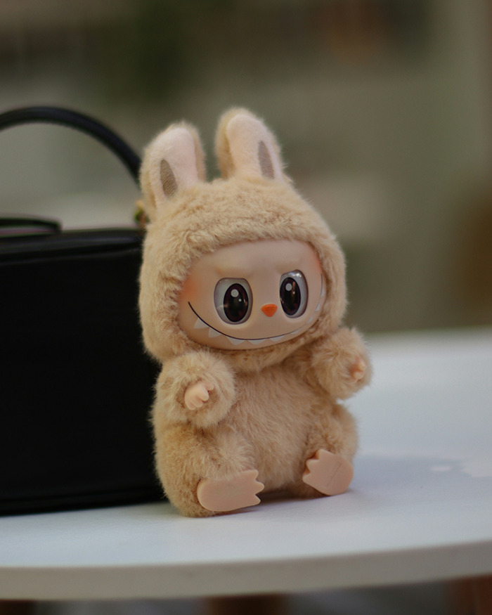 Plush Labubu figure with large eyes and a mischievous smile, highlighting Labubu dark conspiracy concerns in the city.