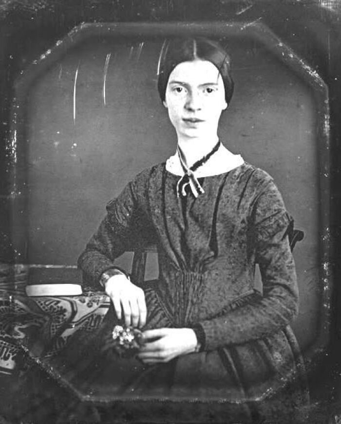 Black and white old photo of a young woman in vintage dress, showcasing unique old photos with incredible stories behind them.