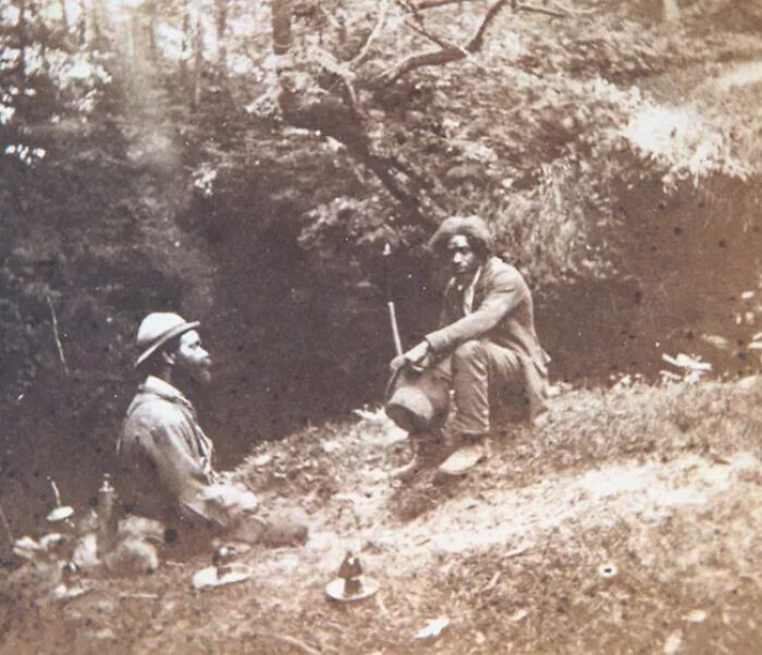 Black and white unique old photo of a man sitting outdoors holding a hat, showcasing historic and rare moments.