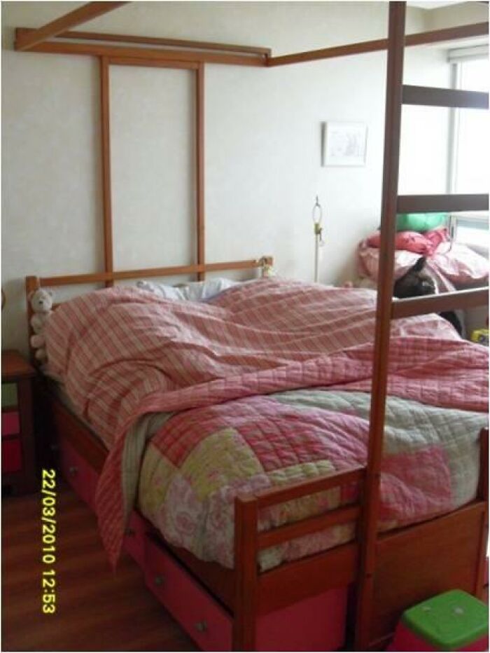 Bed with pink plaid bedding and stuffed animals in a room, linked to terrifying and horrific backstories photos. - 31