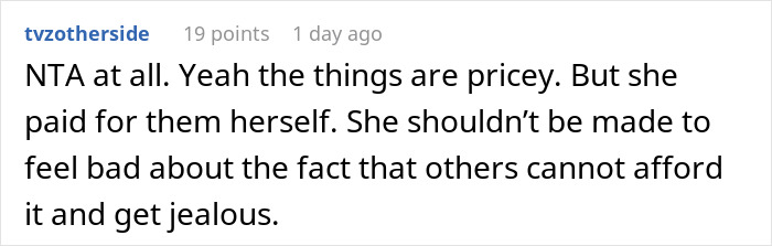 Screenshot of a Reddit comment defending a 21-year-old spending her money on a family vacation despite causing jealousy.