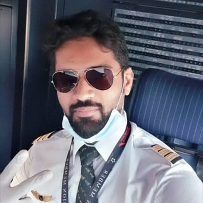 Pilot in Air India uniform wearing sunglasses inside cockpit highlighting final words between Air India pilots on crash cause