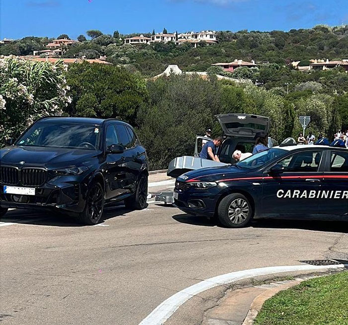 Police and black vehicle at the scene where family of babysitter fatally hit by wife of Lufthansa CEO mourn after passing