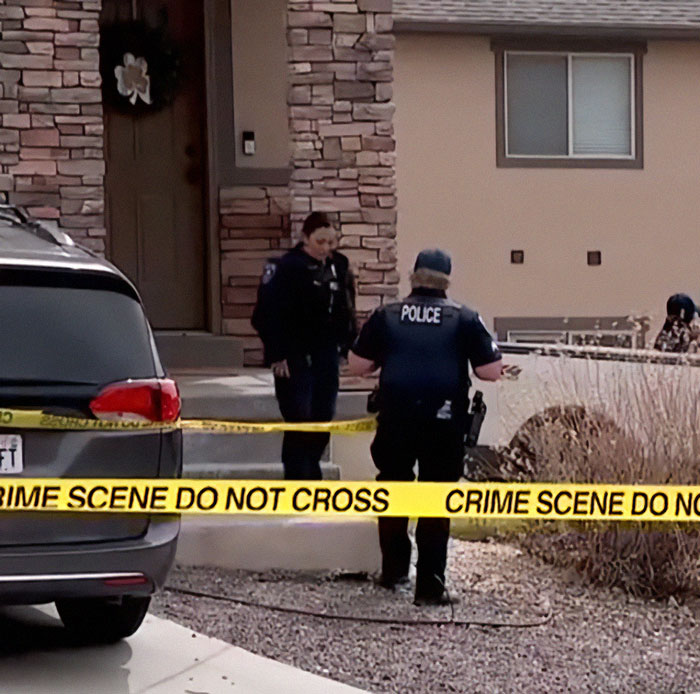 Police officers at a crime scene outside a house marked with yellow tape after teen sent vile texts to family members