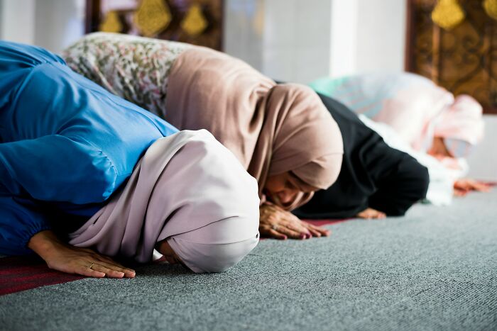 Women in hijabs praying in a mosque, illustrating reflection on common religious myths about Jesus and the Bible.