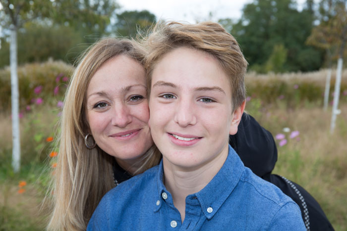 Teen and woman smiling outdoors, representing a family dynamic involving a teen&rsquo;s dad and stepmom expectations.