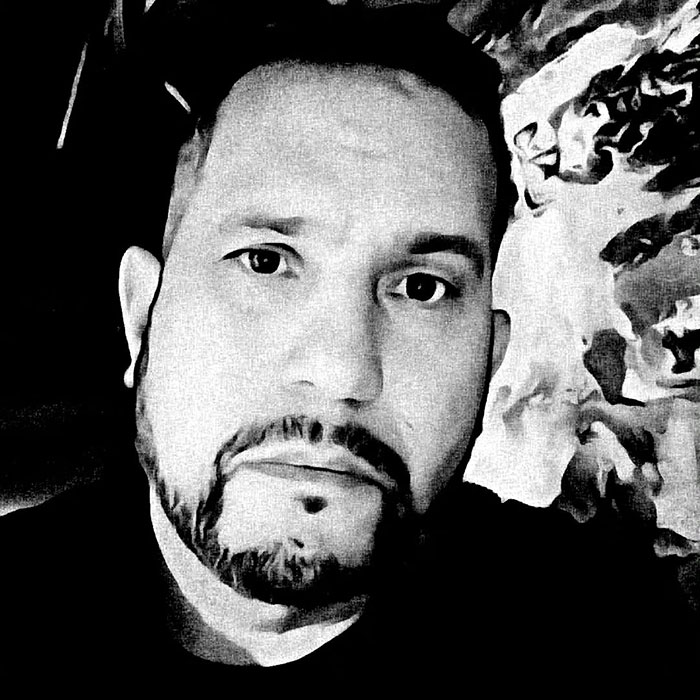 Black and white close-up of a man with a beard, related to paranormal investigator and possessed Annabelle doll story. - 2