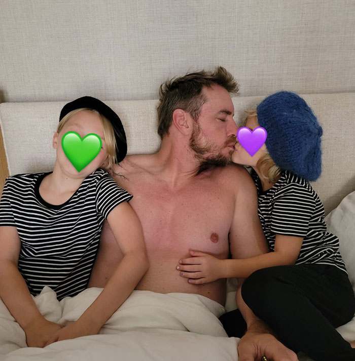 Dax Shepard shirtless in bed with kids, sharing a candid moment highlighting the suns out buns out vibe.