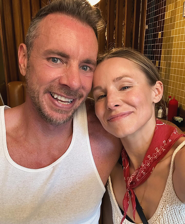 Dax Shepard and Kristen Bell smiling together in a casual indoor setting, sharing a relaxed moment. - 2