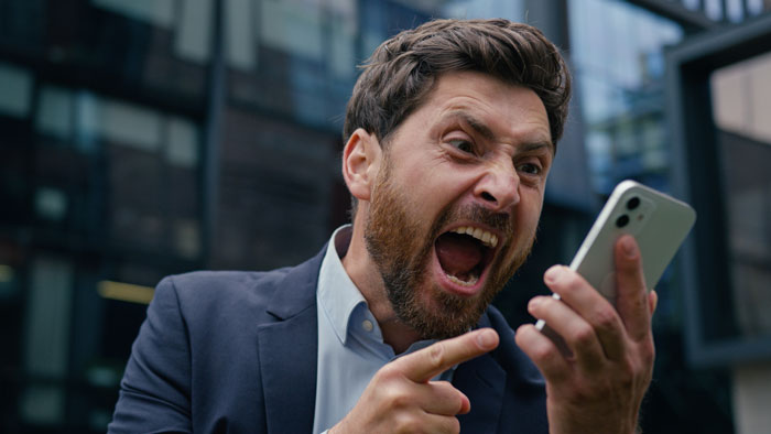 Angry man in business suit yelling at smartphone, illustrating frustration during custody week no-shows and CPS involvement. Angry man in business suit yelling at smartphone, illustrating frustration during custody week no-shows and CPS involvement.
