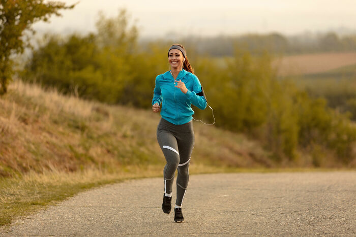 Woman jogging outdoors on a path, illustrating experiences shared by deaf people with surprisingly silent things.