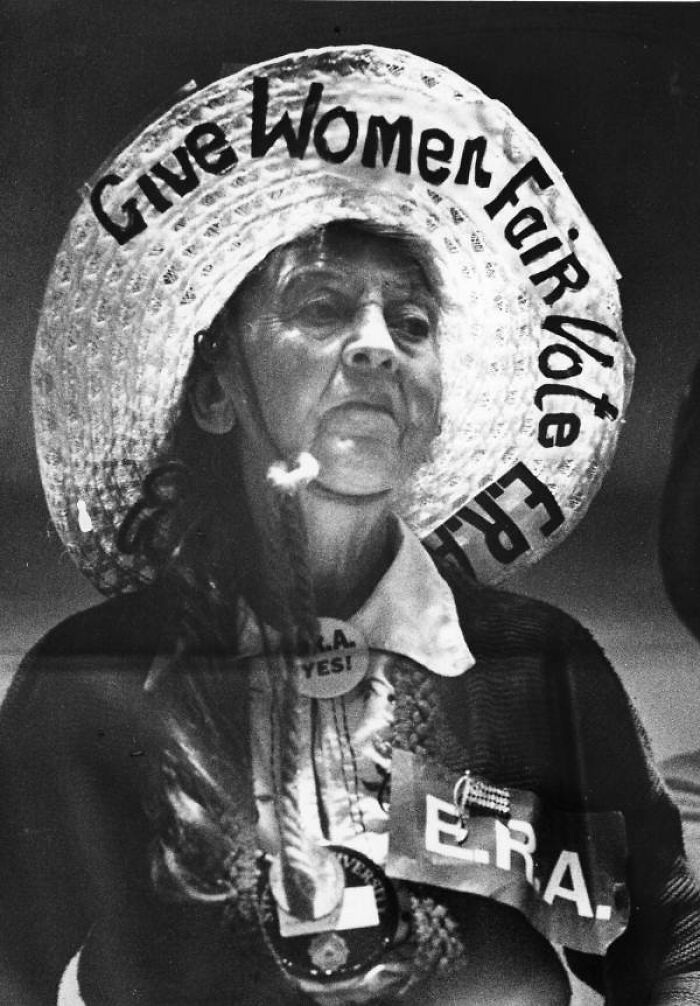 Woman wearing a hat with Give Women Fair Vote slogan, advocating for women's rights in Florida breaking barriers in the 1970s.