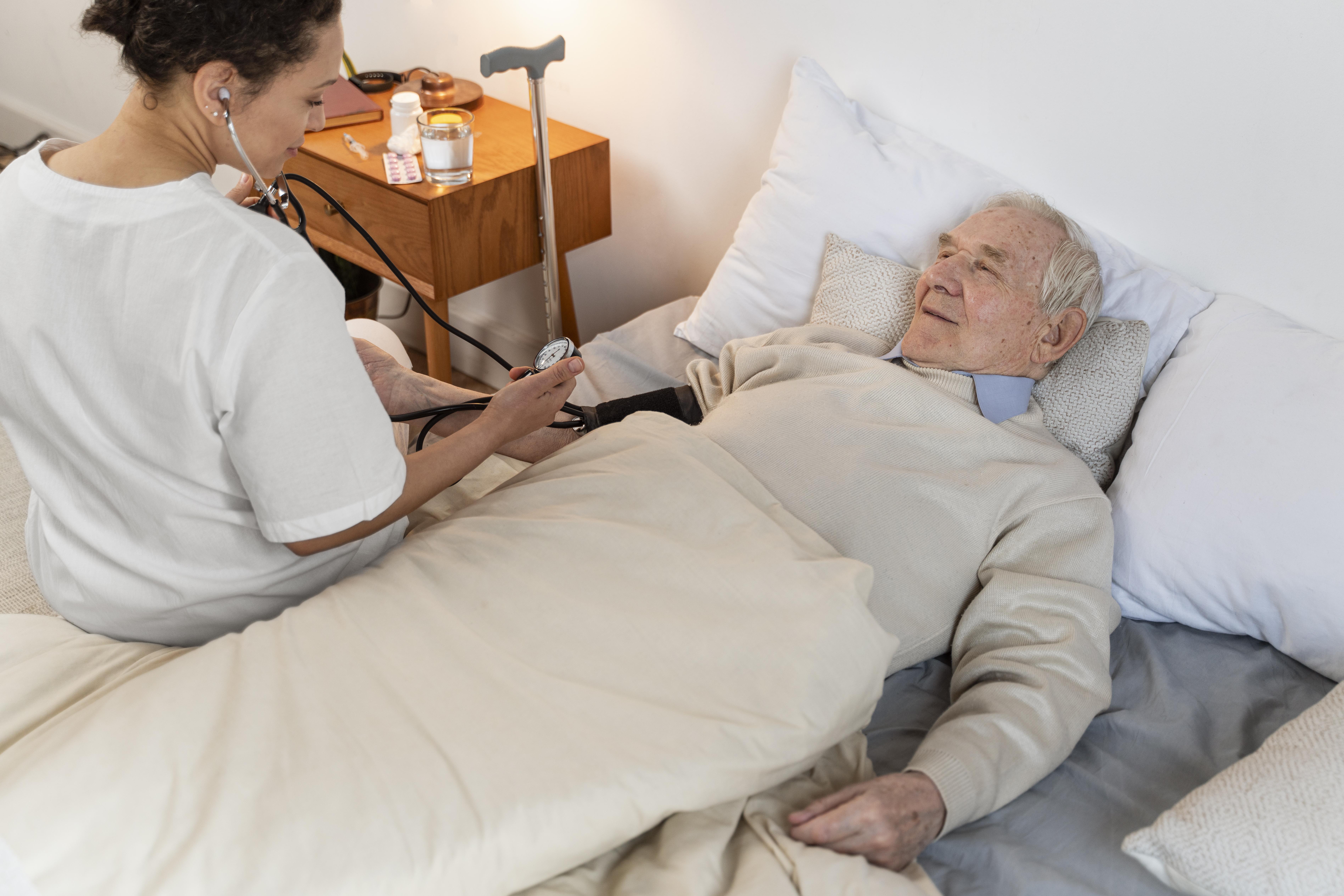 Elderly man in bed with nurse checking blood pressure illustrating family drama inherit house aunt living rent-free