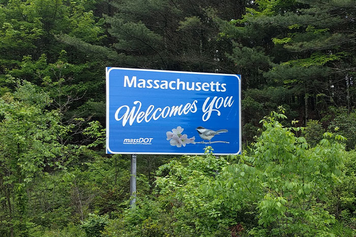 Massachusetts welcome sign surrounded by green trees, illustrating people realizing they were doing something the wrong way. - 29