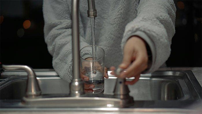 Person filling a glass with water at a kitchen sink, illustrating moments of realizing they were doing something the wrong way. - 13