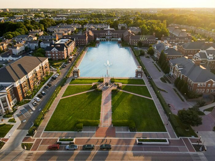 Aerial view of a residential area with a large pond and fountain, representing best places to live in the USA.