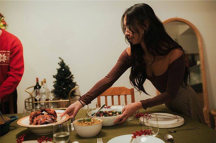 Woman refusing to help others at dinner table, illustrating moments people decided to stop helping others. - 4