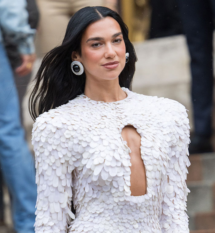 Woman in a white textured dress and statement earrings showcasing a viral celebrity look at Paris Fashion Week 2025. Woman in a white textured dress and statement earrings showcasing a viral celebrity look at Paris Fashion Week 2025.