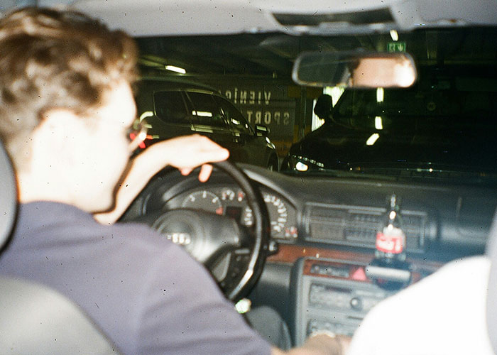 Young driver behind the wheel in a parking garage illustrating dumbest reasons that almost cost people their lives.