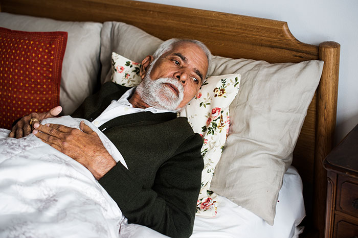 Elderly man lying in bed appearing reflective, illustrating dramatic deathbed confessions without actual death. - 13