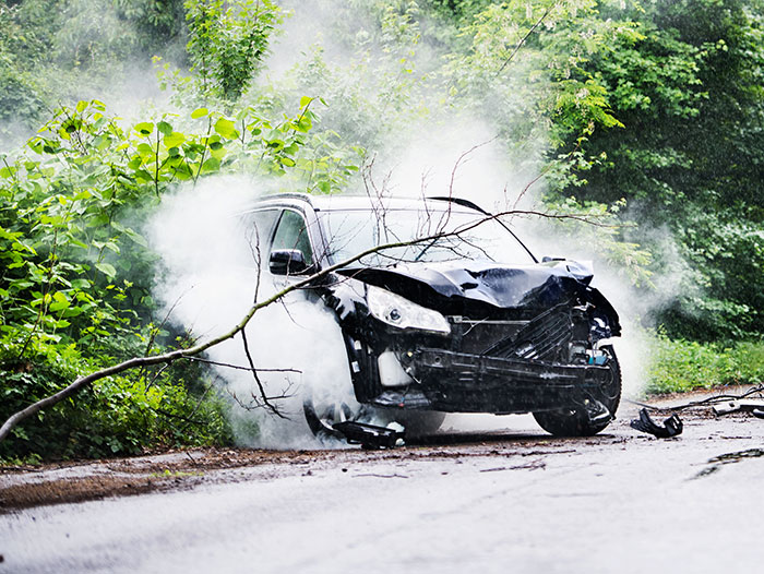 Black car with heavy front damage and smoke after crash, illustrating dramatic deathbed confessions that didn't lead to death. - 33