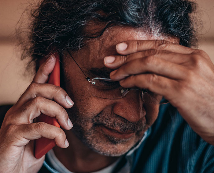 Middle-aged man with glasses making a dramatic deathbed confession on phone, showing stress and emotion. - 23