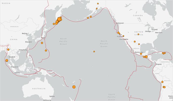 Map showing first tsunami waves hitting Alaska and Japan after major earthquake, with seismic activity marked across Pacific Rim.