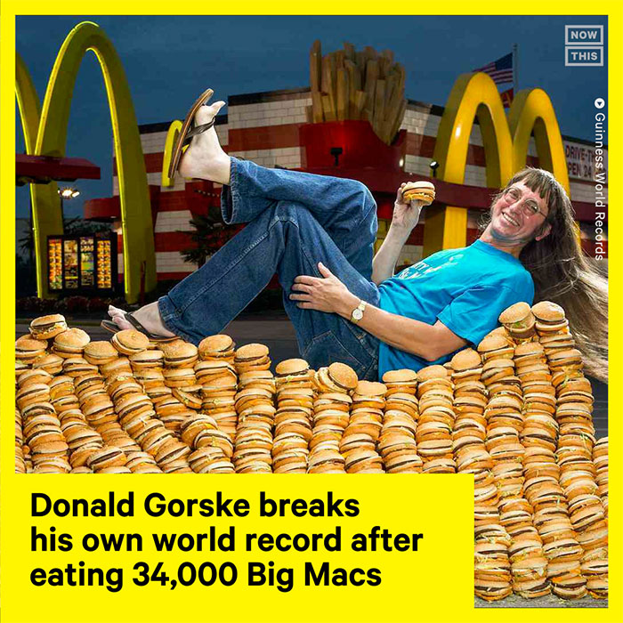 Donald Gorske reclining on a pile of Big Macs outside McDonald's, highlighting easiest world records to break with time.