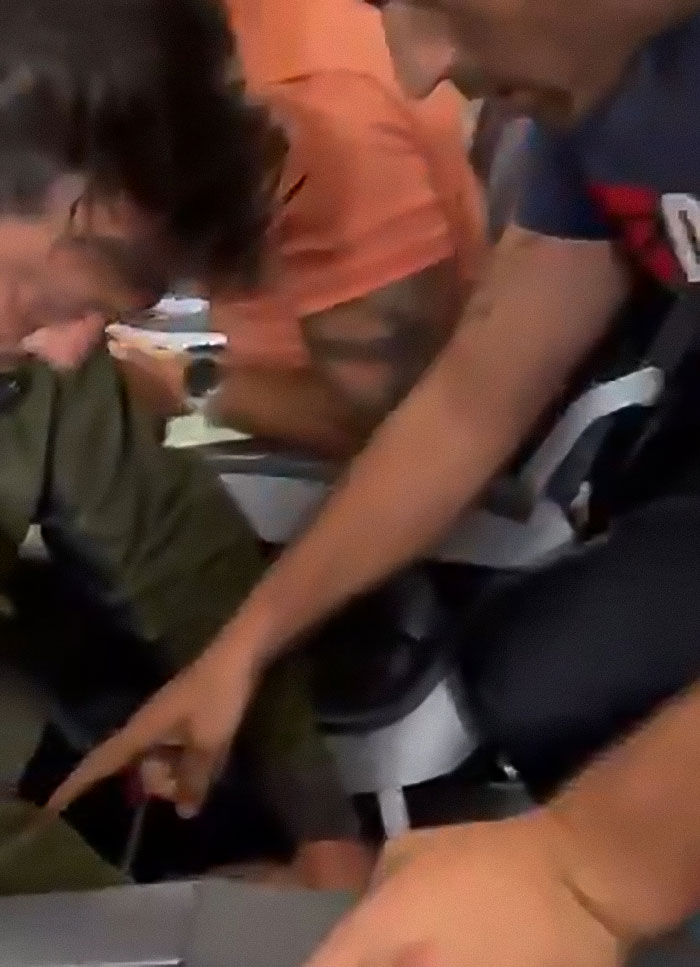 Passengers tackling man who threatens to explode plane mid-flight in dramatic altercation inside airplane cabin.