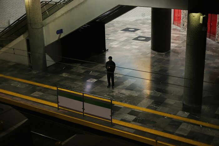 Person standing alone in an empty, dimly lit urban space, symbolizing hard-to-believe personal stories shared by people.