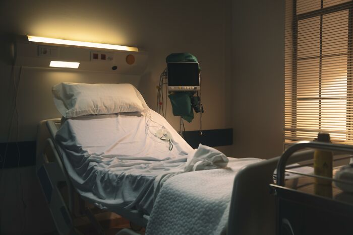 Hospital bed in a dimly lit room symbolizing doctors encountering impostor patients needing less meds and common sense