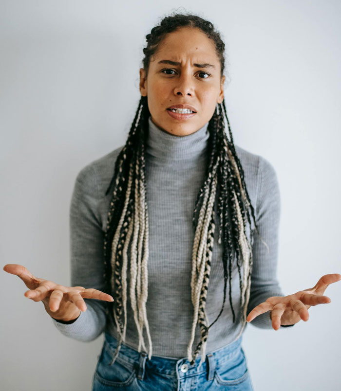 Woman with braided hair expressing frustration and anger after being denied plasma donation and accusing staff of racism. Woman with braided hair expressing frustration and anger after being denied plasma donation and accusing staff of racism.