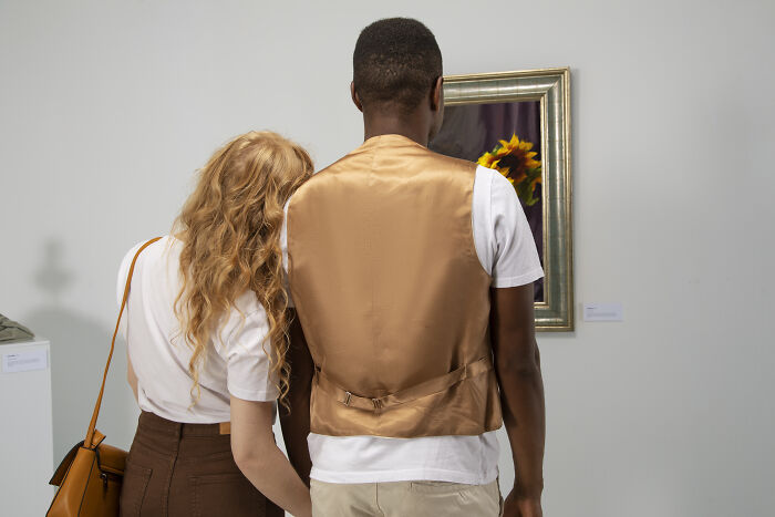 Two people viewing artwork in a gallery, illustrating escape room employees stories with curiosity and teamwork. - 27