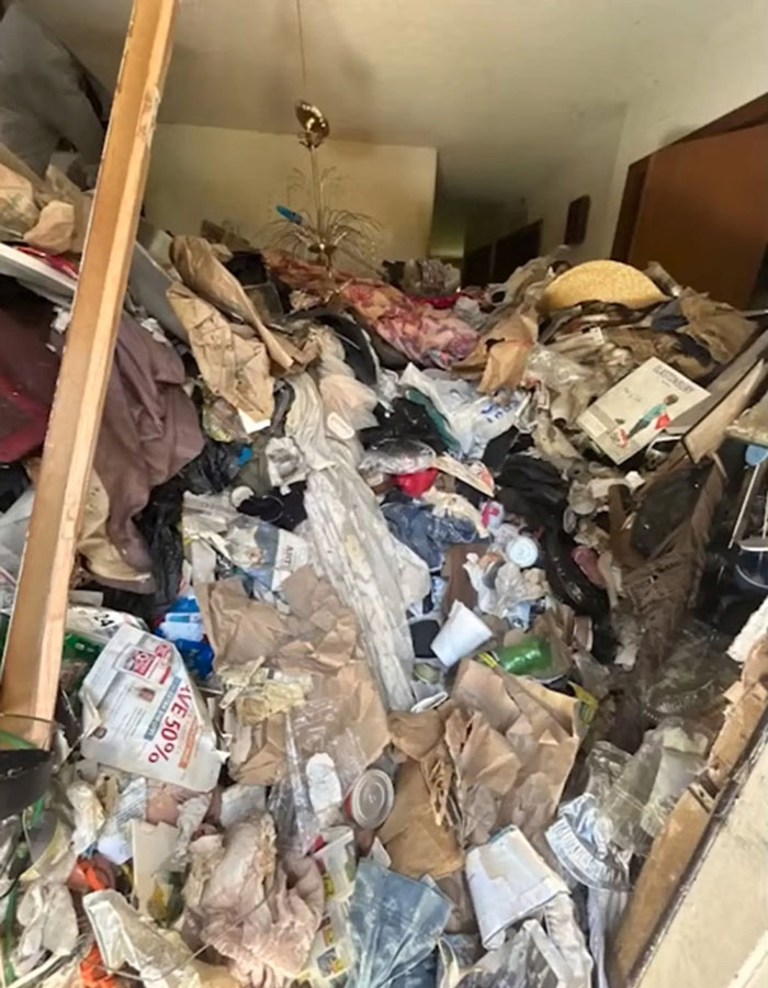 Cluttered hoarder house filled with trash and debris where police discovered skeletal remains of ex-cop.