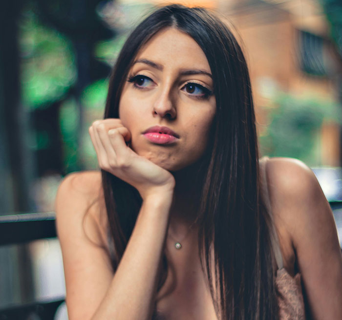 Young woman looking pensive outdoors, reflecting on meeting ex and the possibility of co-parenting a secret child. Young woman looking pensive outdoors, reflecting on meeting ex and the possibility of co-parenting a secret child.