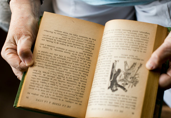 Hands holding an old vintage book, illustrating thoughtful gifts that feel personal and expensive.