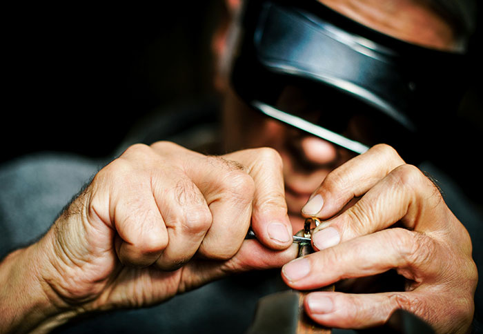 Close-up of a craftsman’s hands creating a personal and thoughtful gift with detailed precision and care.