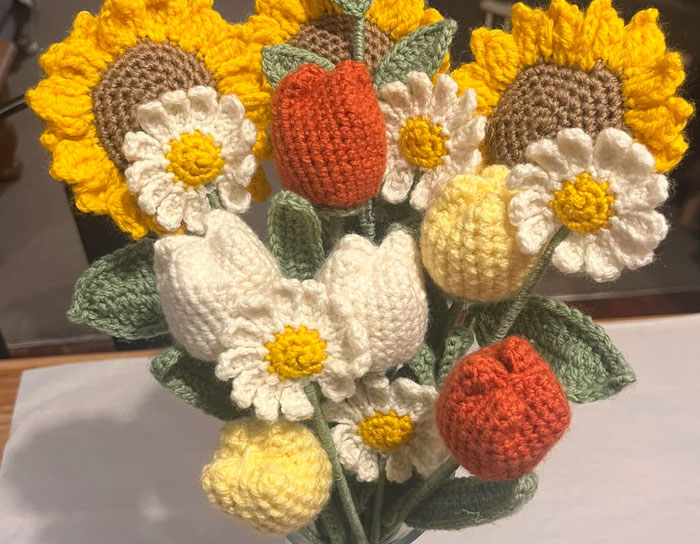Crocheted flowers including sunflowers, daisies, and tulips arranged as personal and thoughtful gifts that feel expensive.