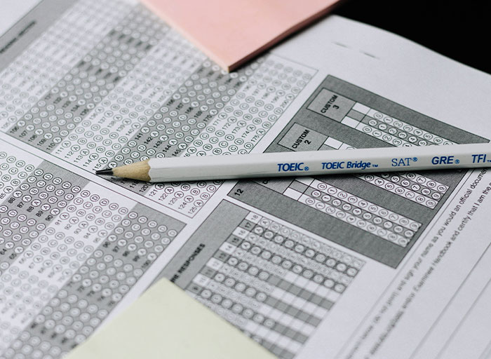 Pencil resting on a multiple-choice test sheet, illustrating thoughtful and personal gifts related to education and achievement.