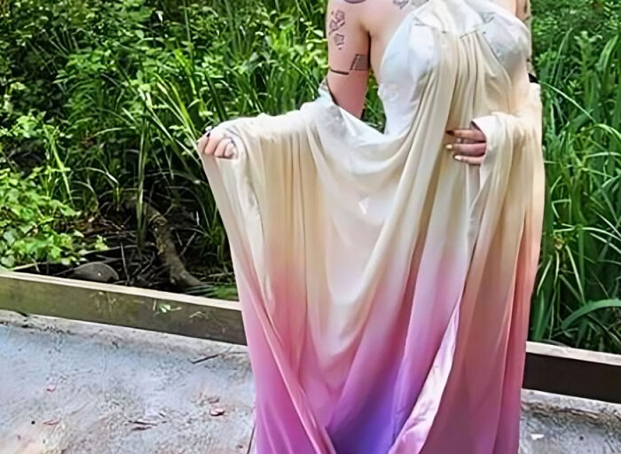 Person wearing a flowing ombre dress outdoors, representing personal and thoughtful gifts that feel expensive