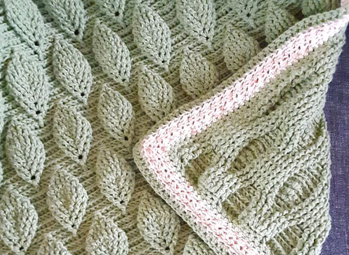 Handcrafted knitted blanket with intricate leaf patterns, a personal and thoughtful gift that feels super expensive.