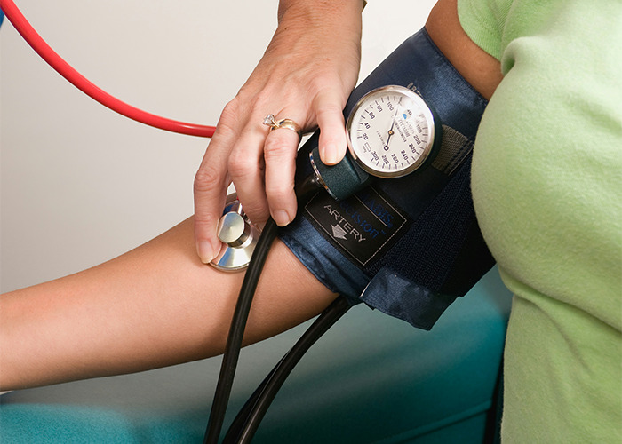 Medical professional measuring blood pressure using a cuff and stethoscope highlighting health risks of death machines. - 18