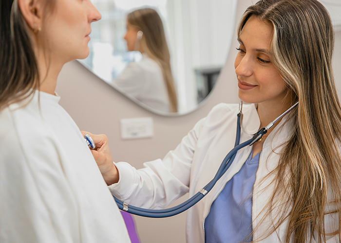 Doctor using a stethoscope to examine a patient, highlighting insights doctors wish more people knew. - 39
