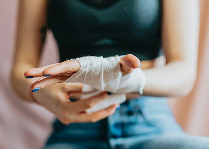 Person wrapping hand with medical bandage, highlighting doctors' warnings about death machines and health risks. - 26