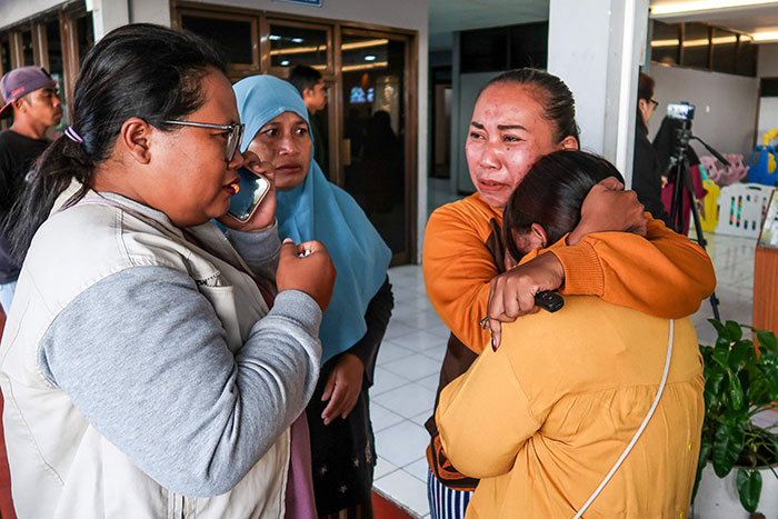 Relatives and rescuers emotionally distressed after ferry sank off Bali, with four dead and dozens still missing.