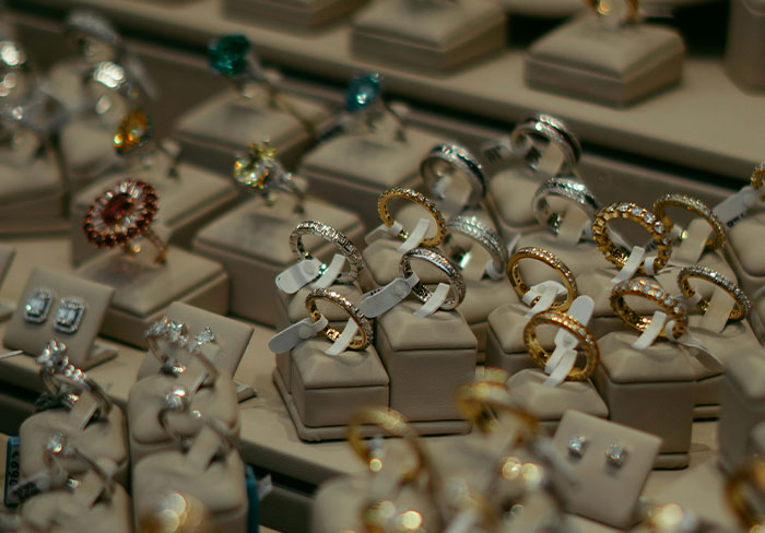 Display of various gold and silver rings and earrings in a jewelry store, highlighting family heirloom items value.
