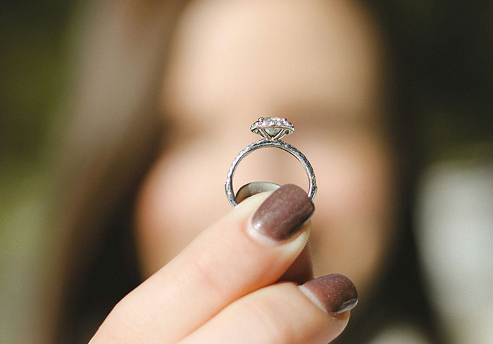 Close-up of a woman holding a family heirloom ring that is unexpectedly worth only thirty dollars.