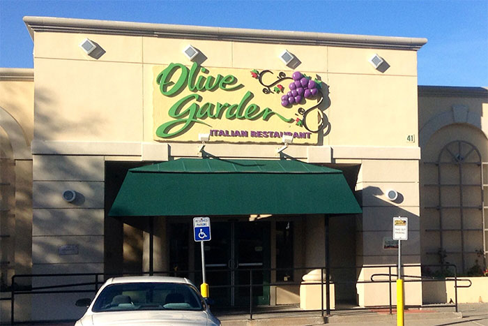 Front view of Olive Garden restaurant with accessible parking, illustrating a workplace where employees might quit on the spot.