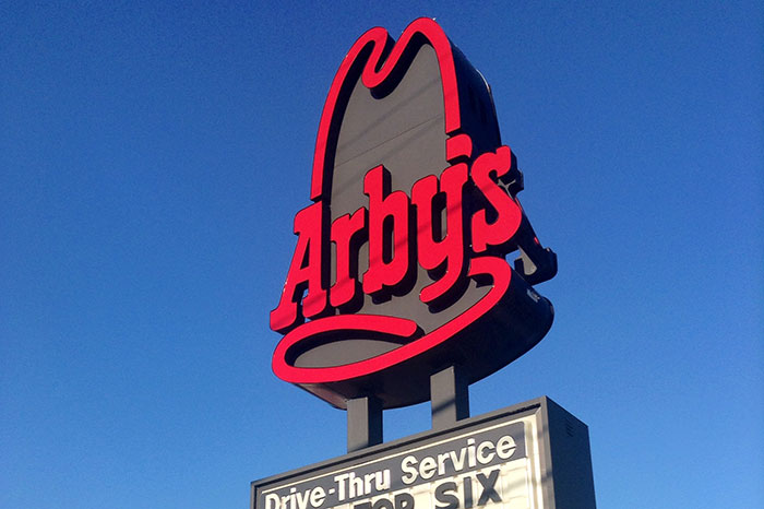 Arbys restaurant sign against blue sky, illustrating bad job experience and quitting almost immediately concept.