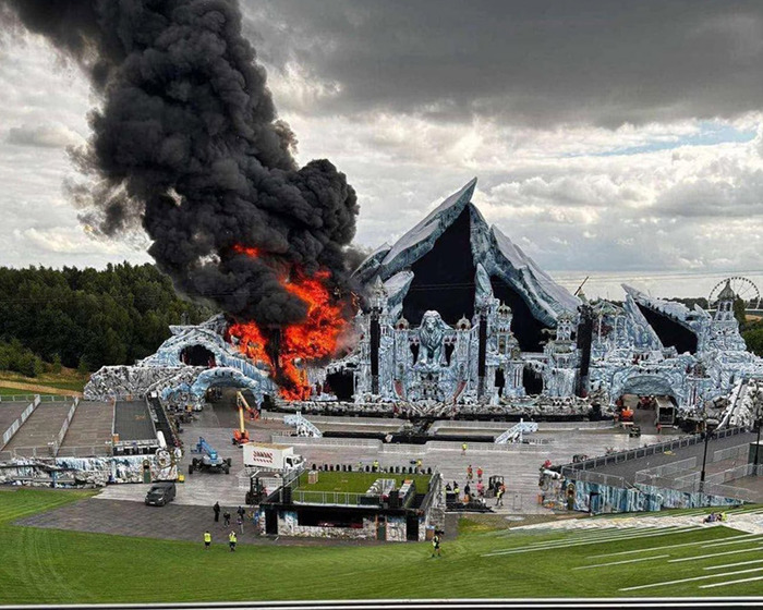 Massive fire engulfs Tomorrowland main stage with thick black smoke rising before the festival's opening day.